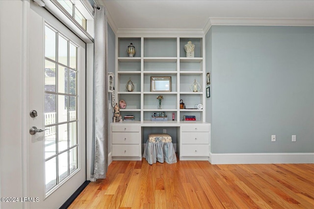 interior space with crown molding, a wealth of natural light, and light wood-type flooring