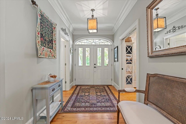 foyer featuring ornamental molding and hardwood / wood-style floors