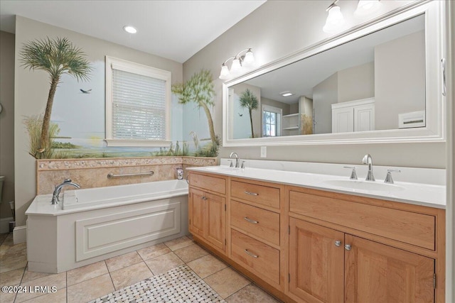 bathroom featuring tile patterned floors, vanity, and a tub