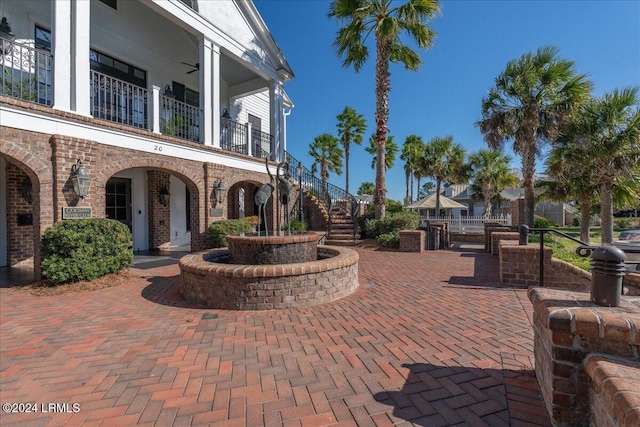 view of patio featuring ceiling fan and a balcony