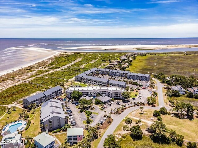 drone / aerial view with a water view and a view of the beach