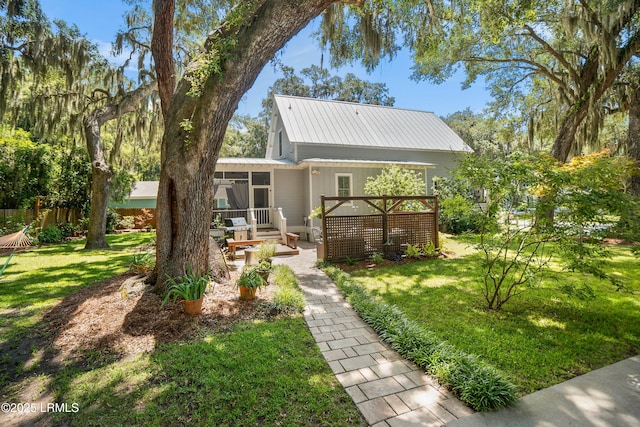 1108 12th St, Port Royal, SC 29935 - back of property featuring a sunroom, a metal roof, a patio area, and a wooden deck