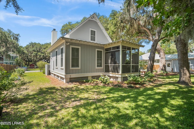 1108 12th St, Port Royal, SC 29935 - rear view of house featuring a chimney and a sunroom