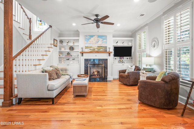 1108 12th St, Port Royal, SC 29935 - living room featuring crown molding, stairway, a ceiling fan, light wood-style floors, and recessed lighting
