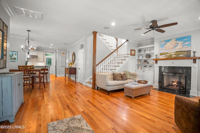 1108 12th St, Port Royal, SC 29935 - living area featuring stairs, light wood finished floors, ornamental molding, recessed lighting, and a fireplace