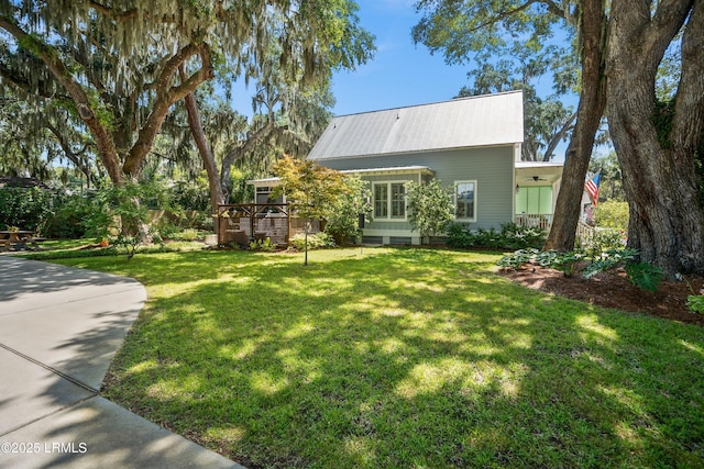 1108 12th St, Port Royal, SC 29935 - view of front facade featuring a wooden deck, a front yard, and a metal roof