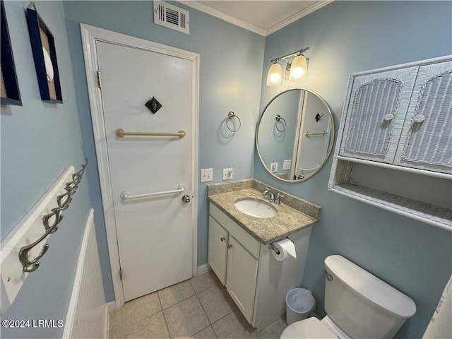 bathroom featuring vanity, tile patterned flooring, ornamental molding, and toilet