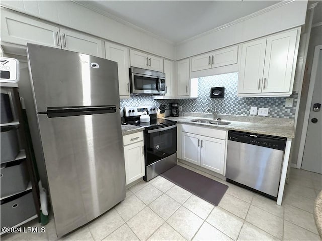 kitchen featuring sink, white cabinetry, crown molding, tasteful backsplash, and stainless steel appliances