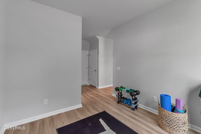 interior space featuring light wood-type flooring and baseboards