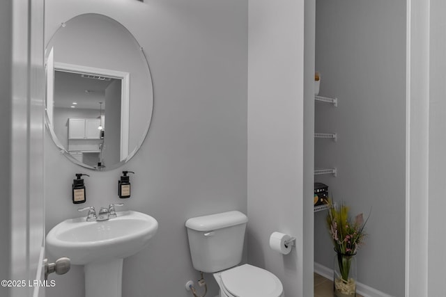 bathroom with visible vents, a sink, and toilet