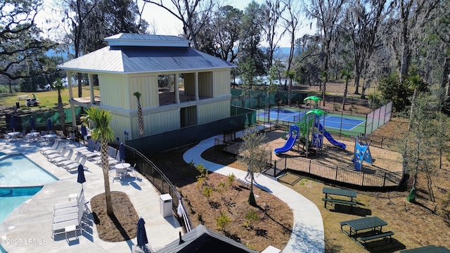 exterior space with fence and a community pool