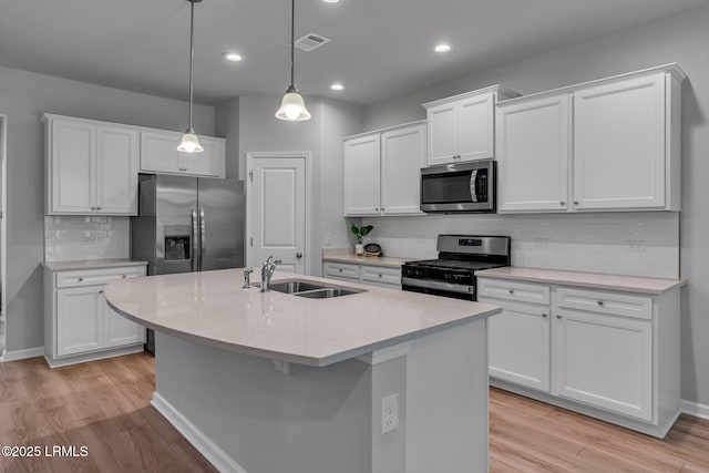 kitchen with stainless steel appliances, visible vents, and white cabinets