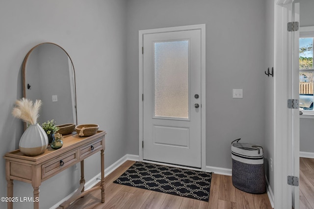 entryway featuring light wood-type flooring and baseboards