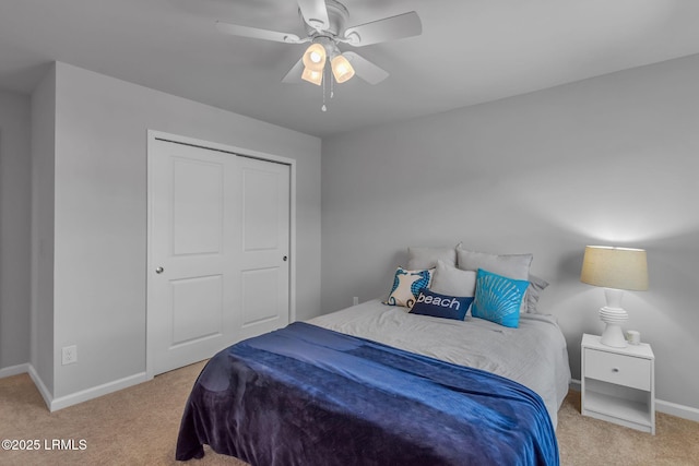 carpeted bedroom with a closet, ceiling fan, and baseboards