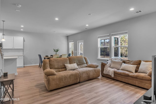 living area featuring recessed lighting, baseboards, visible vents, and light wood finished floors