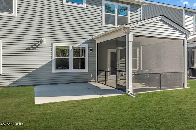 back of house with a yard, a patio area, and a sunroom