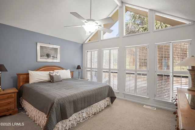 carpeted bedroom with visible vents, ceiling fan, and high vaulted ceiling