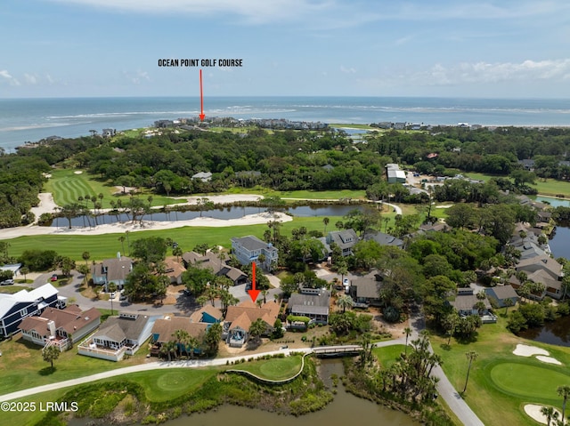 drone / aerial view featuring view of golf course, a water view, and a residential view