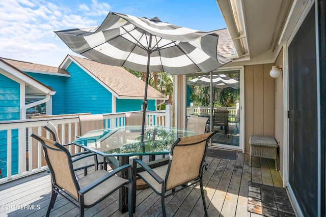 wooden terrace with outdoor dining area
