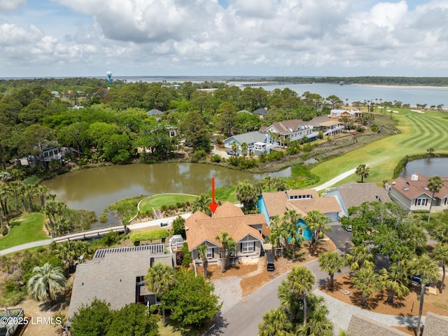 drone / aerial view featuring a residential view, a water view, and view of golf course