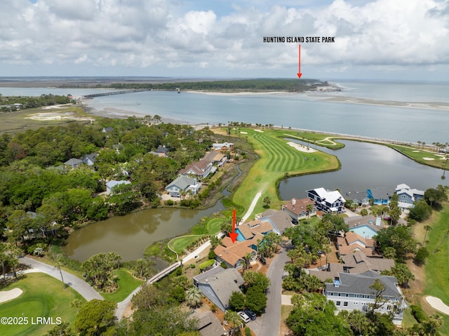 birds eye view of property with a water view, a residential view, and view of golf course