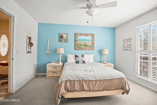 carpeted bedroom with ceiling fan and baseboards