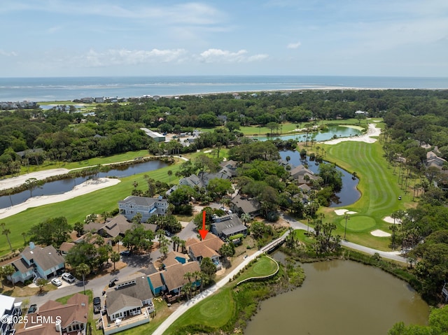 birds eye view of property with a residential view, a water view, and view of golf course