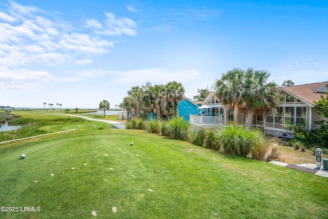 view of community featuring a yard and a water view