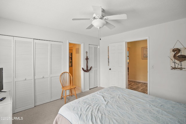 bedroom with ceiling fan, baseboards, and carpet floors