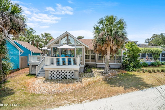 view of front of home with a sunroom and a deck
