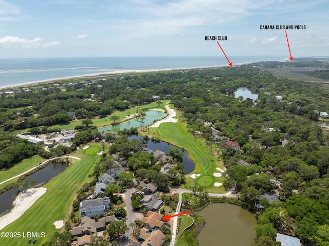 drone / aerial view with golf course view, a water view, and a residential view