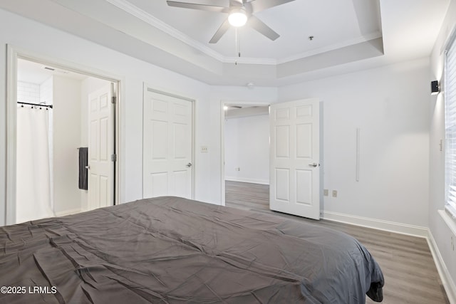 4924 Bluffton Pkwy Unit 18-106, Bluffton, SC 29910 - bedroom with wood finished floors, baseboards, ornamental molding, a tray ceiling, and a ceiling fan