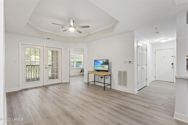4924 Bluffton Pkwy Unit 18-106, Bluffton, SC 29910 - living area with a raised ceiling, light wood finished floors, ceiling fan, baseboards, and crown molding