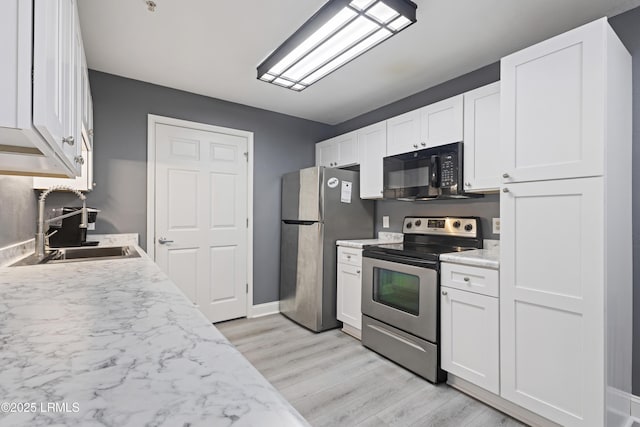 4924 Bluffton Pkwy Unit 18-106, Bluffton, SC 29910 - kitchen with appliances with stainless steel finishes, a sink, light wood finished floors, and light countertops