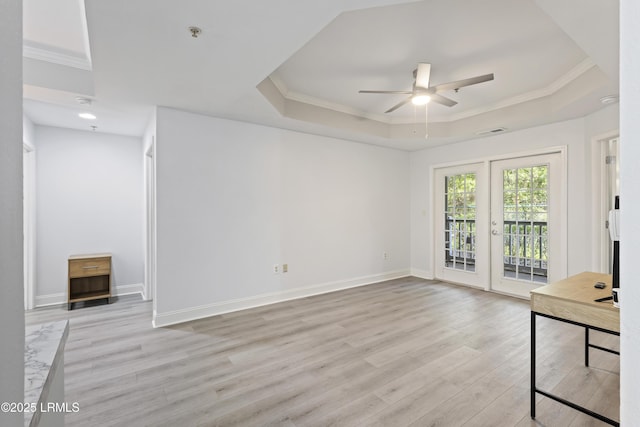 4924 Bluffton Pkwy Unit 18-106, Bluffton, SC 29910 - unfurnished living room featuring a raised ceiling, a ceiling fan, light wood finished floors, crown molding, and baseboards
