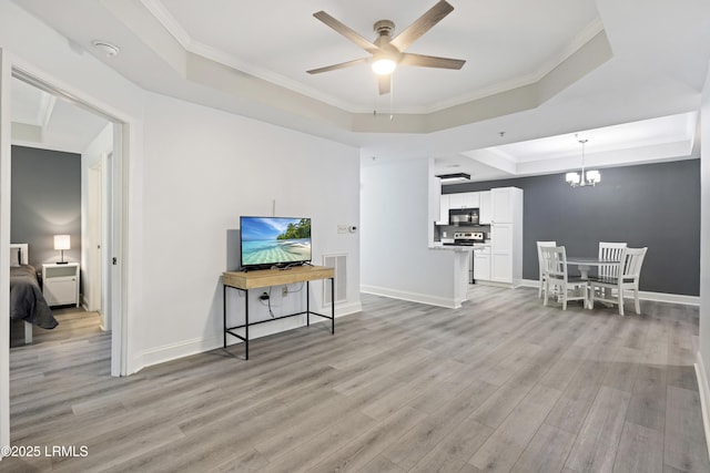 4924 Bluffton Pkwy Unit 18-106, Bluffton, SC 29910 - living area with a raised ceiling, light wood-type flooring, a ceiling fan, crown molding, and a chandelier