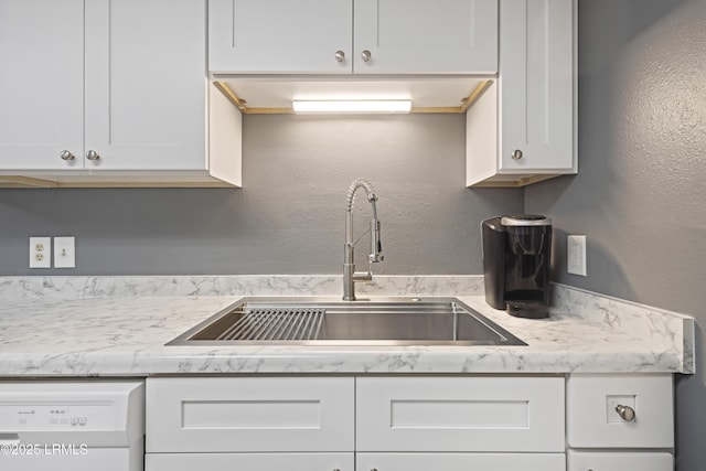 4924 Bluffton Pkwy Unit 18-106, Bluffton, SC 29910 - kitchen featuring a sink, white dishwasher, white cabinets, a textured wall, and light stone counters