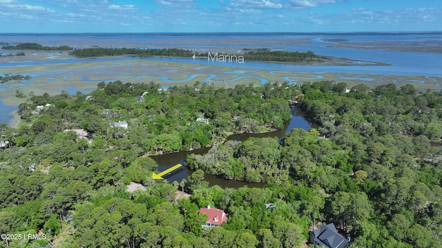 drone / aerial view featuring a water view and a wooded view