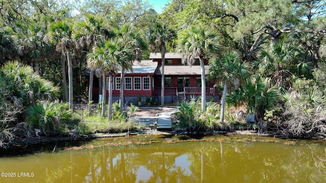 back of house with a deck with water view