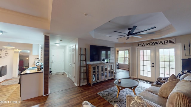 living room featuring french doors, ceiling fan, dark hardwood / wood-style flooring, and a raised ceiling