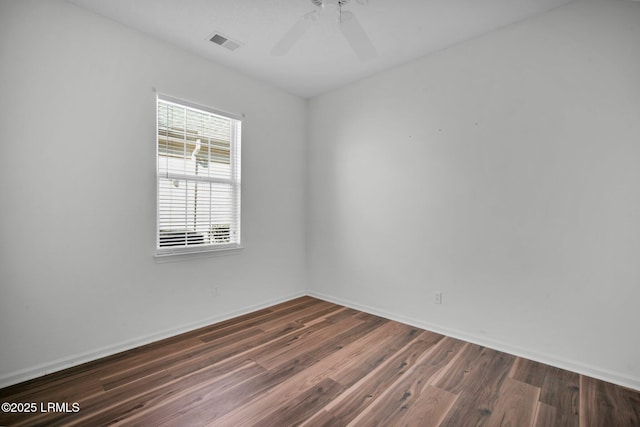 unfurnished room with dark hardwood / wood-style floors and ceiling fan