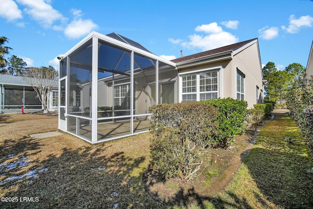 rear view of house featuring a yard and a lanai