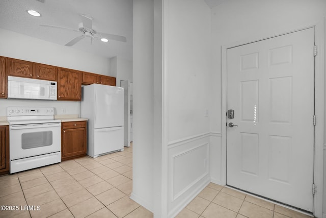 kitchen featuring white appliances, ceiling fan, and light tile patterned flooring