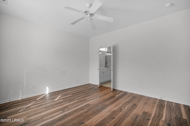 unfurnished room featuring a textured ceiling, dark hardwood / wood-style floors, and ceiling fan