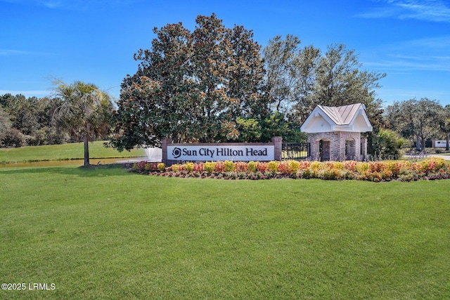 community sign featuring a lawn