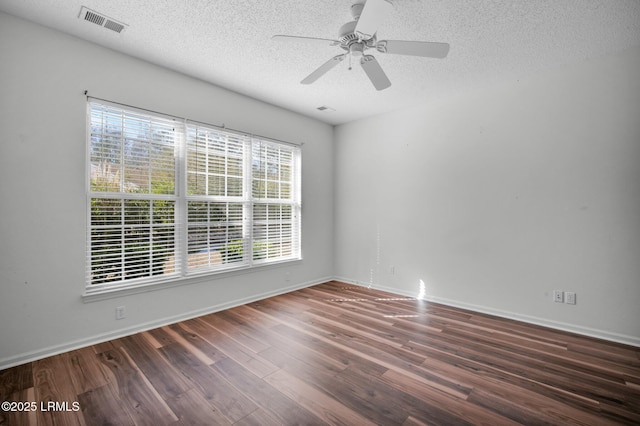 unfurnished room with ceiling fan, dark hardwood / wood-style floors, and a textured ceiling