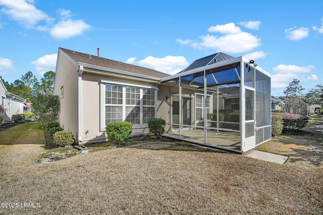 rear view of house with glass enclosure