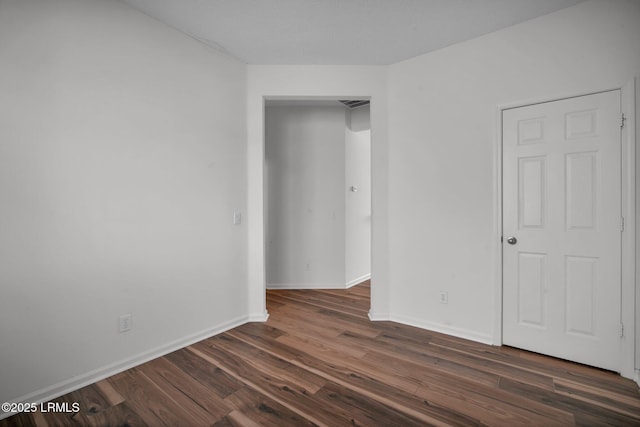 unfurnished bedroom with dark wood-type flooring