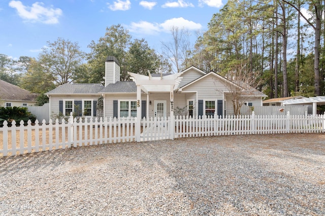 ranch-style home featuring a fenced front yard and a chimney