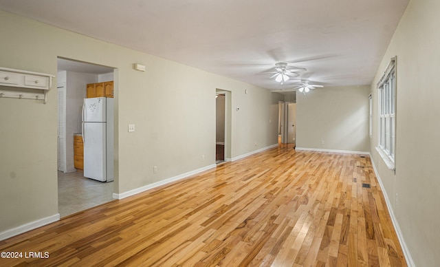 spare room featuring ceiling fan and light wood-type flooring